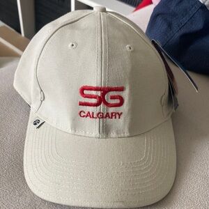 Fersten cream and black cap with SG Calgary embroidered on it